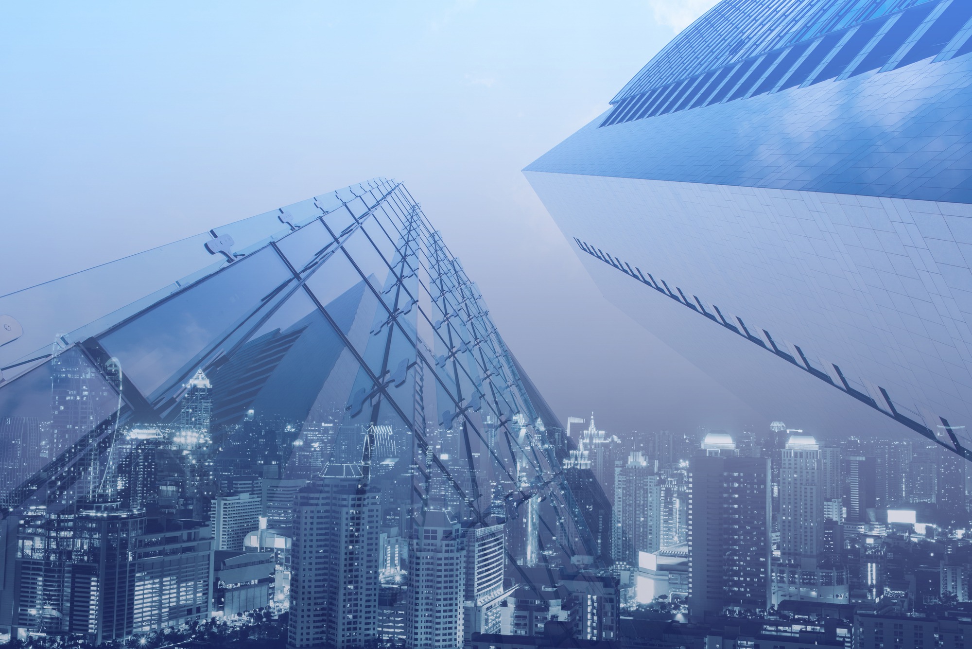 Double exposure, luxury modern highrise buildings and the city can use for business and finance background, blue tone.