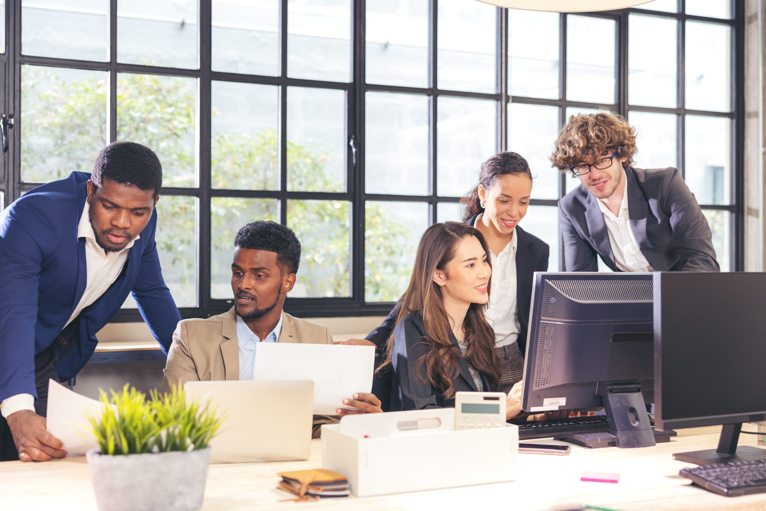 Colleagues in a Boardroom Discussion Seated at a Table Together