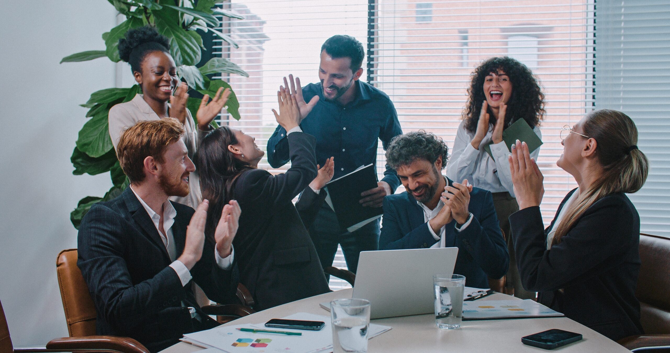 Multi-Ethnic Group of People Consulting Together Looking at Laptop Screen